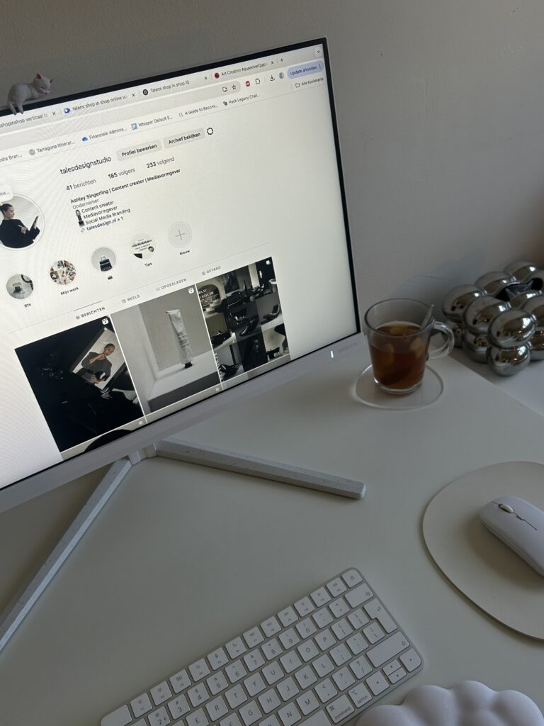 A cozy desk setup featuring a MacBook, iced coffee, dried florals, and a to-do list, styled for a freelance creative or virtual assistant working from home.