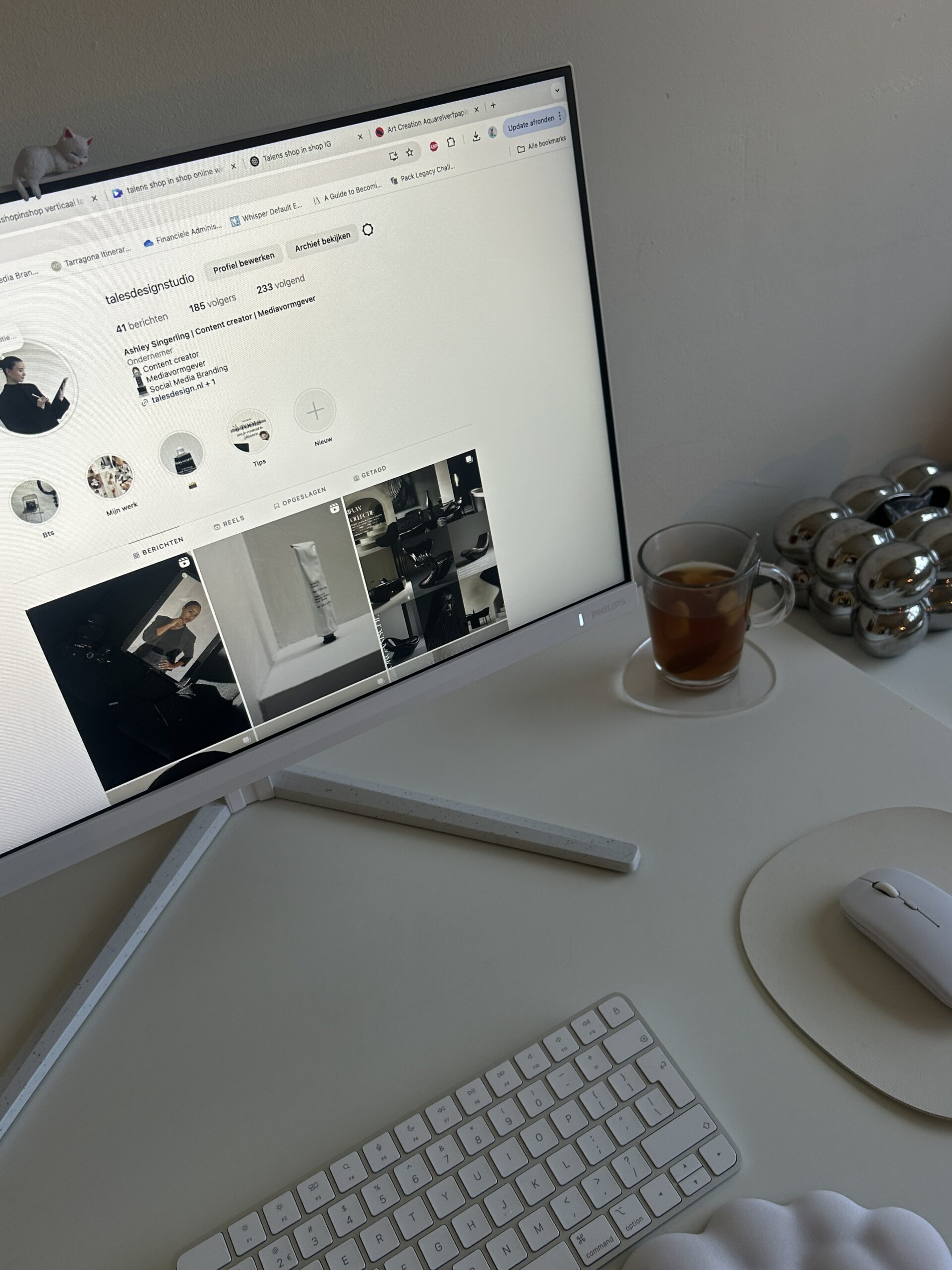 A cozy desk setup featuring a MacBook, iced coffee, dried florals, and a to-do list, styled for a freelance creative or virtual assistant working from home.